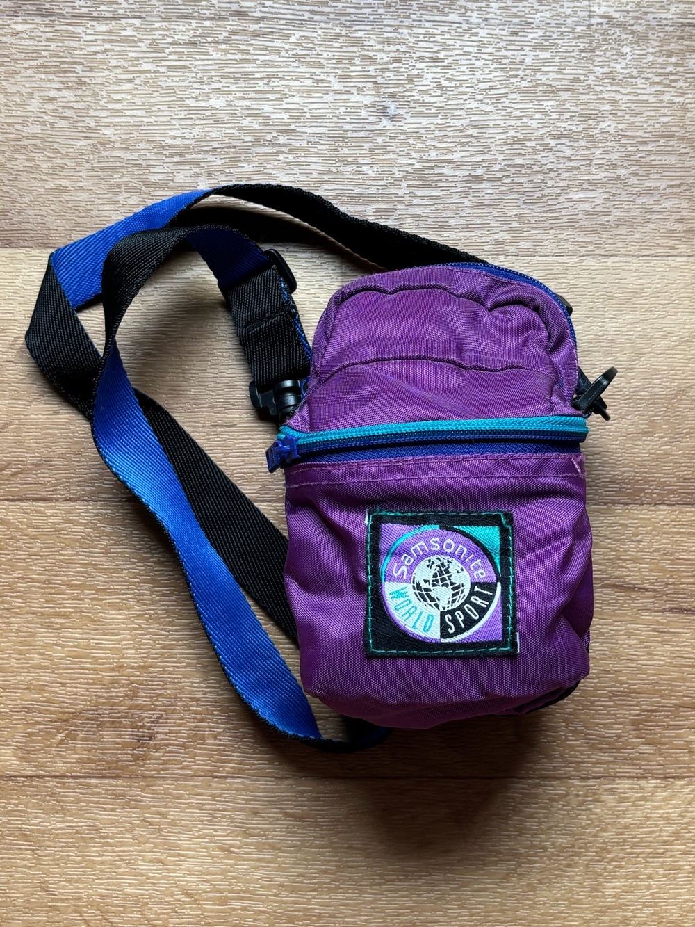 Samsonite Purple Crossbody Bag with Blue Zipper and Strap Accent